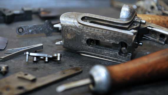 Dismantled gun action on workbench